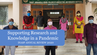 Picture of people in masks outside a hospital with title of annual review in front of them
