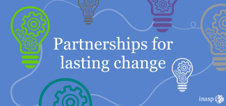Different coloured cartoon lightbulbs with cogs inside on a blue background with the words - partnerships for change in white text in the middle