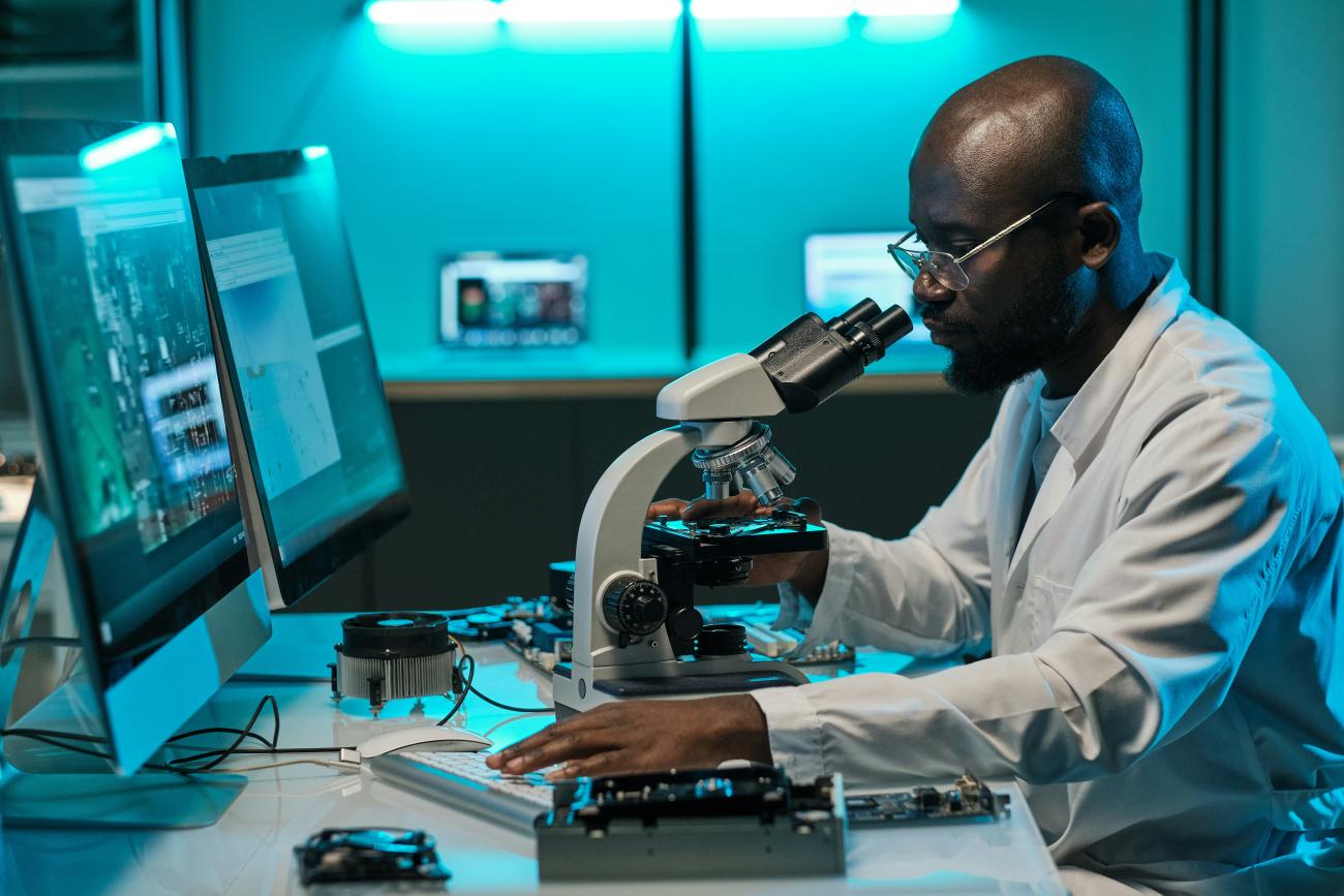 Young African Researcher with Microscope