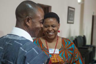 a male and female policymaker engage in lively conversation