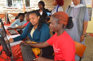 young women sitting at laptops